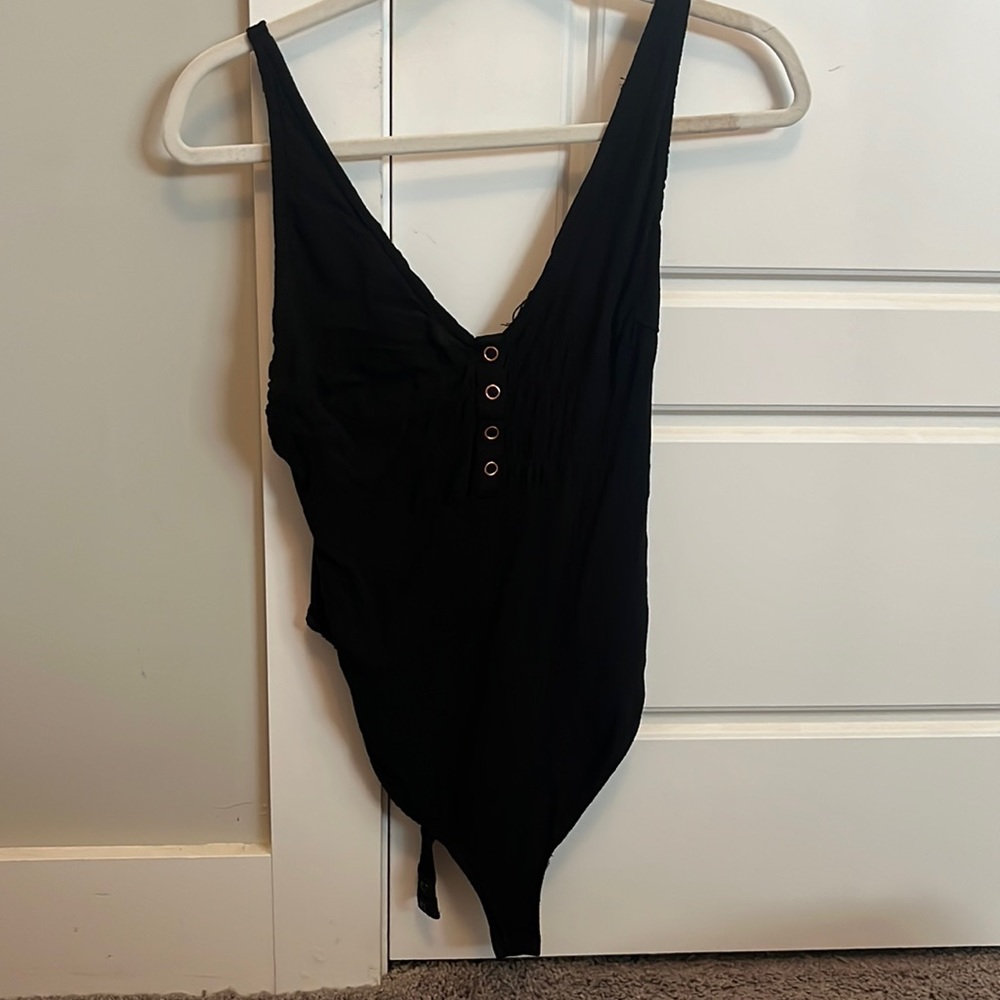 Black body suit with rose gold snap buttons